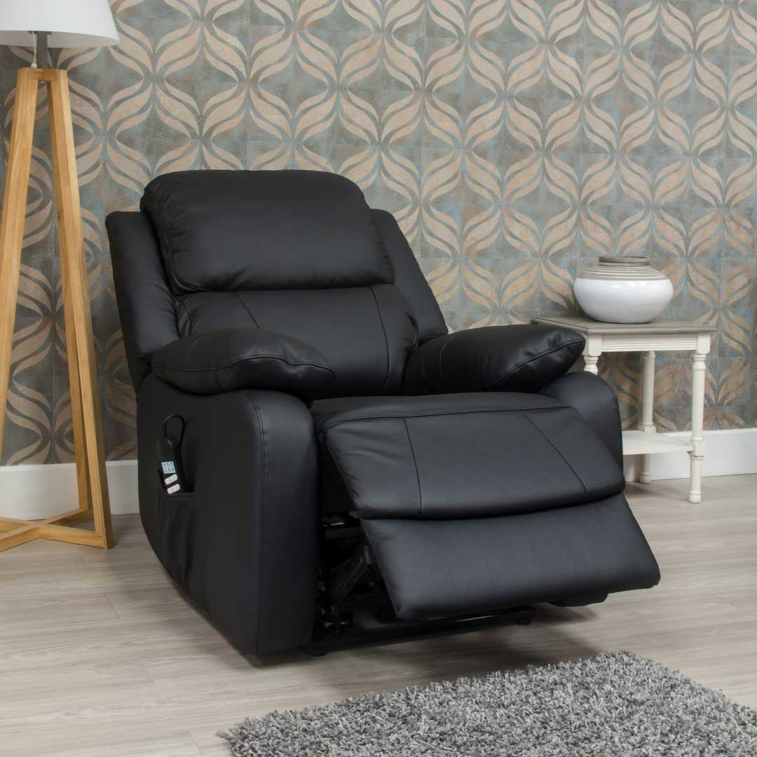 Black leather lift and rise recliner chair in a room with patterned wallpaper and a side table.