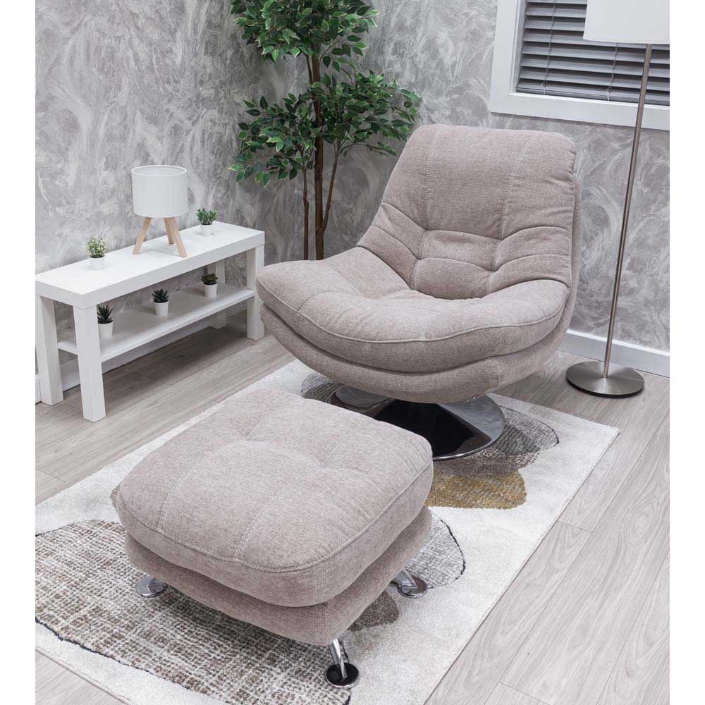 Beige armchair and footstool set in a room with a white table and plant.