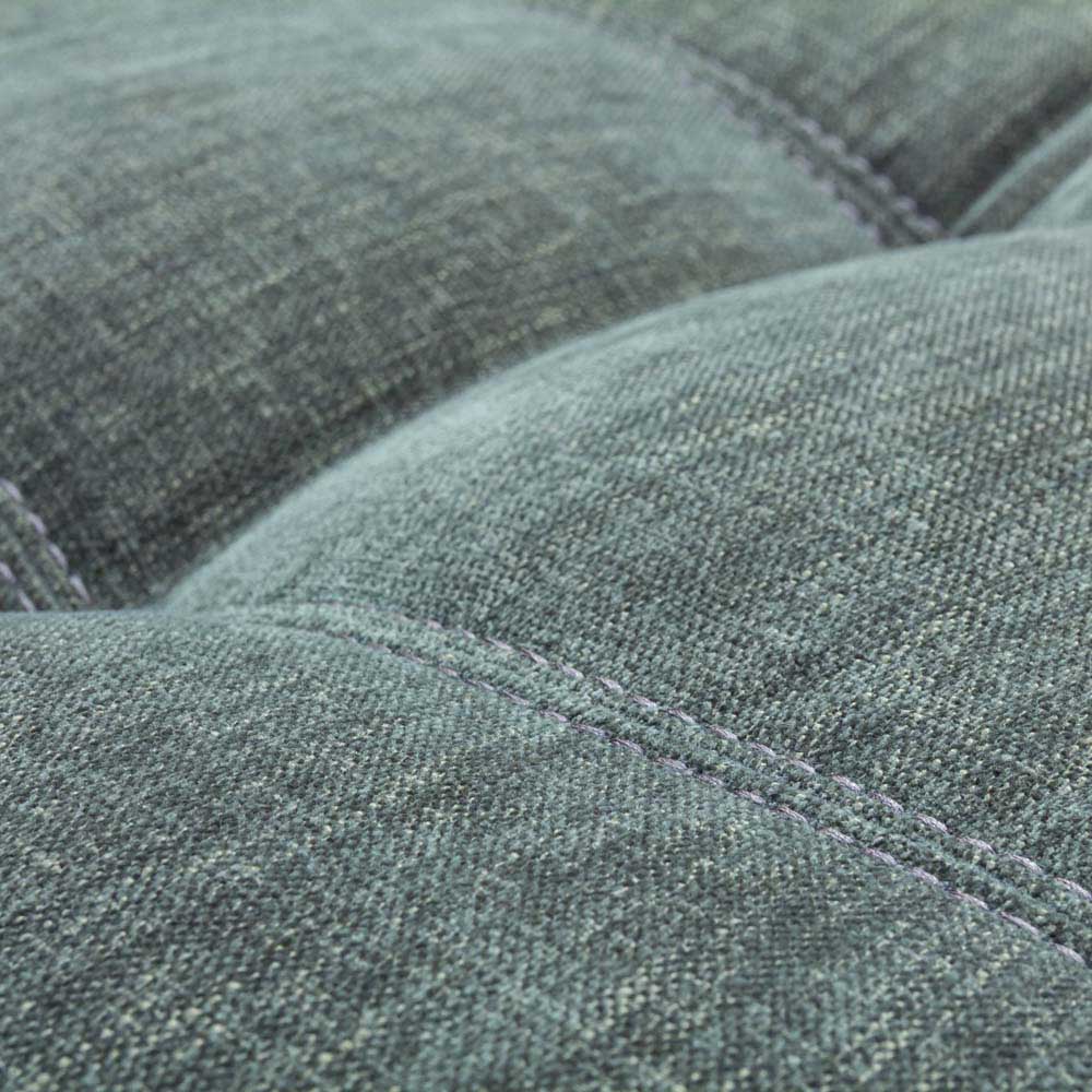Close up of Sage Green footstool upholstry with stitching 