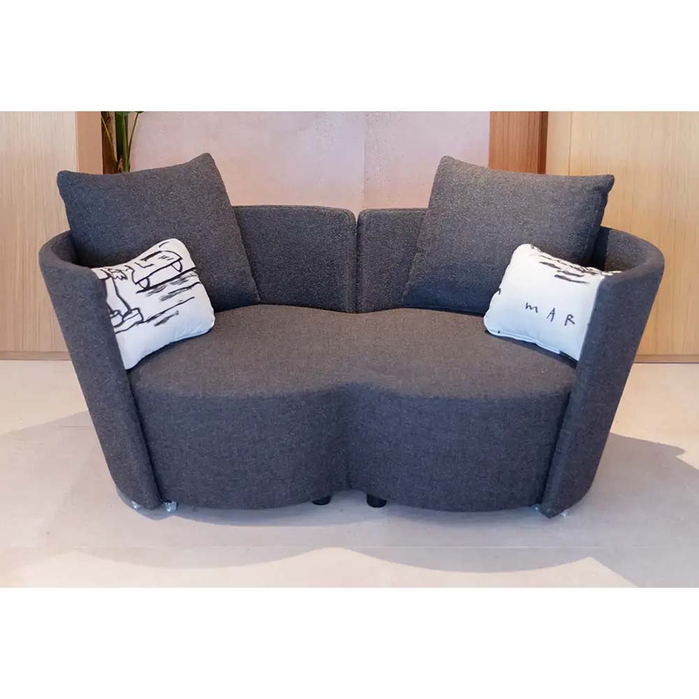 Gray infinity sofa with two cushions on a light wooden floor.