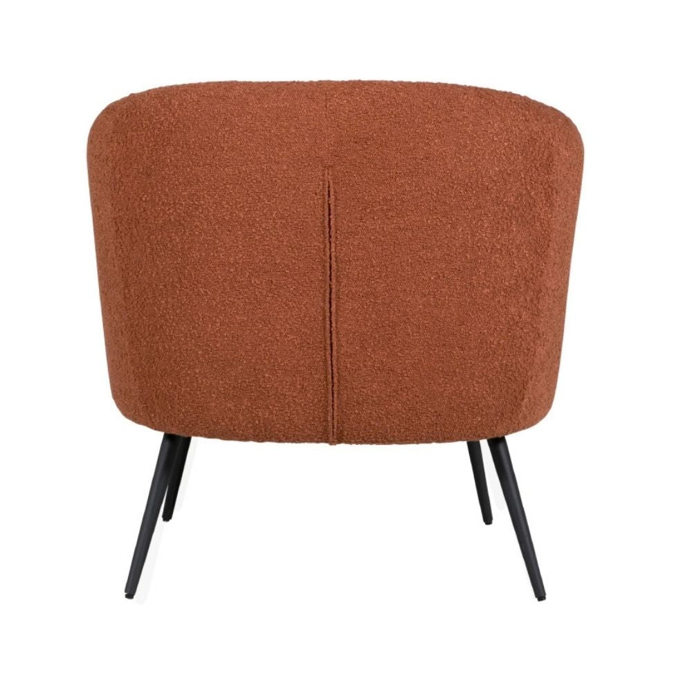 A modern barrel-style armchair upholstered in a textured terracotta bouclé fabric with black tapered metal legs, shown from the back against a plain white background.