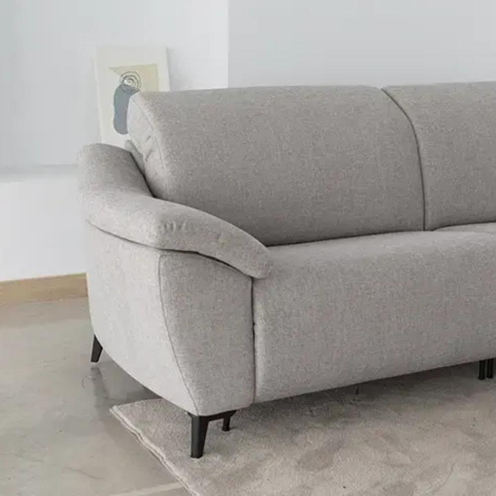 A light gray fabric two-seater sofa with dark tapered legs, shown in a minimalist room setting on a light rug.