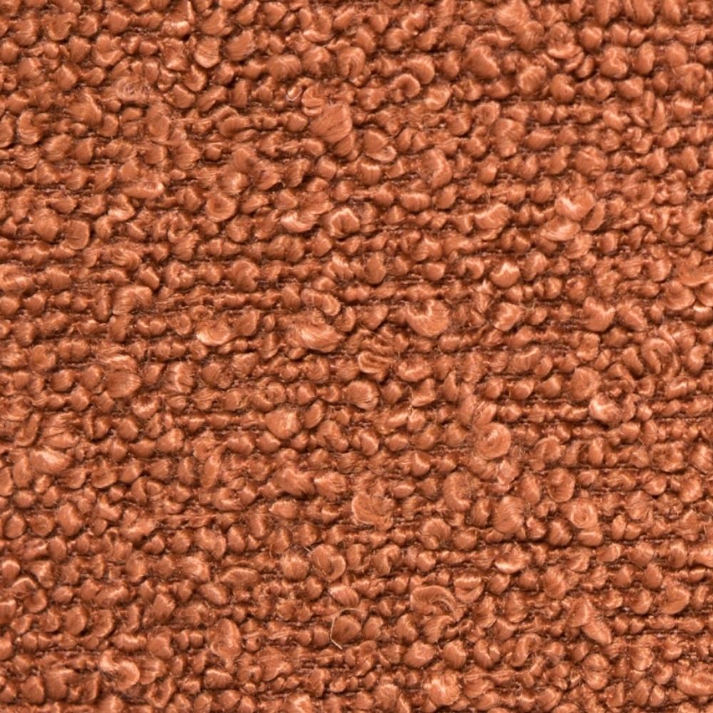 A close-up texture shot of rust coloured bouclé fabric swatch