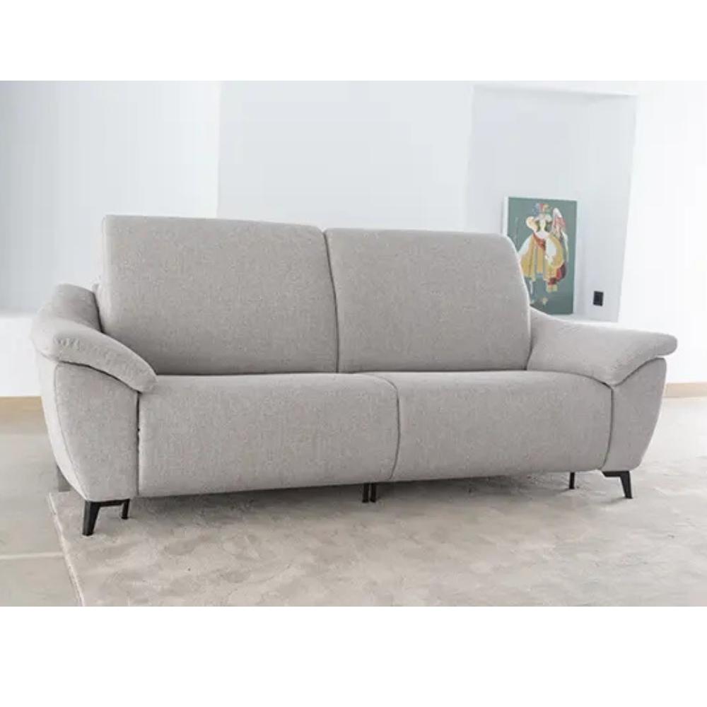 A modern two-seater sofa upholstered in light gray textured fabric, shown in a minimalist room setting with a light gray tiled floor and white walls.