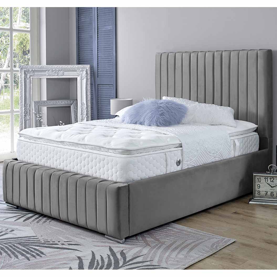 Light Grey upholstered bed with white mattress in a bedroom setting