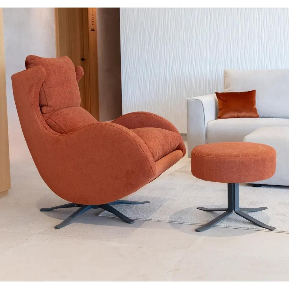 An orange upholstered swivel lounge chair with a matching round footstool, shown in a modern living room setting next to a white sofa.