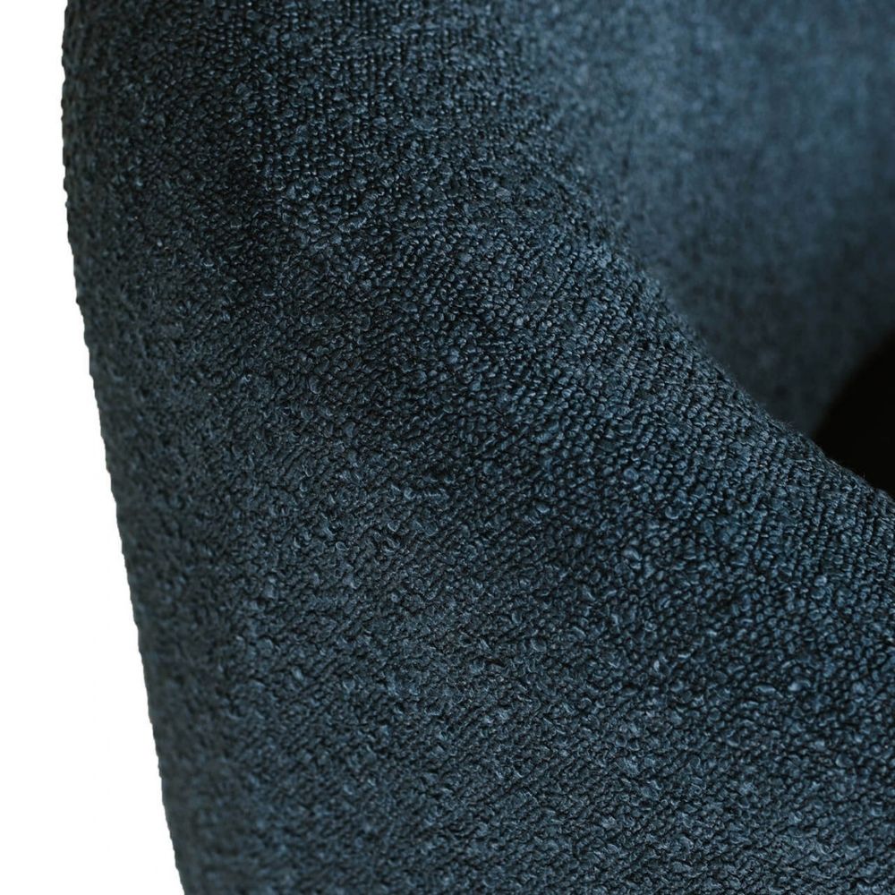 A close-up of a dark slate blue textured fabric, showing the detailed woven pattern and soft folds against a white background.
