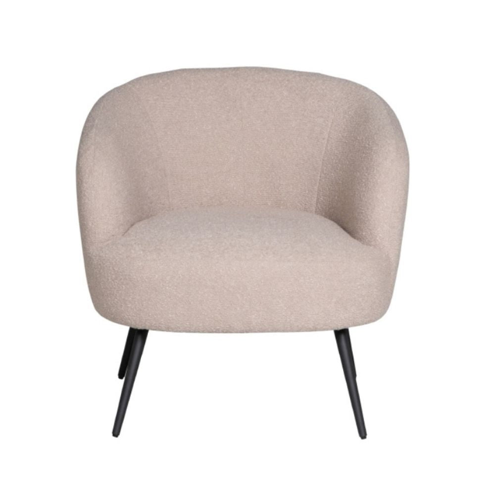A modern barrel-style accent chair upholstered in a textured beige bouclé fabric, featuring a rounded backrest and seat, supported by four tapered black metal legs, shown against a plain white background.