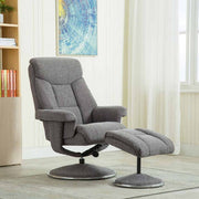 Gray recliner chair with footstool in a room with books and a painting on the wall.