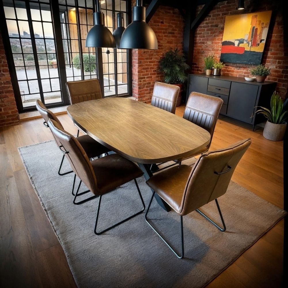 Cognac Alfie chairs around an oval shaped oak meeting table in a conference room setting