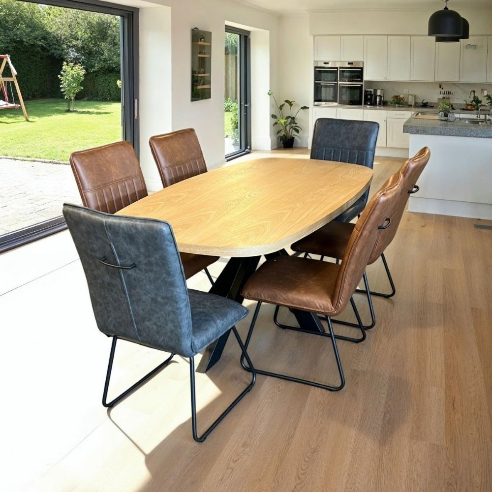 A mixture of congnac and grey alfie dining chairs around an oval dining table in a kitchen setting