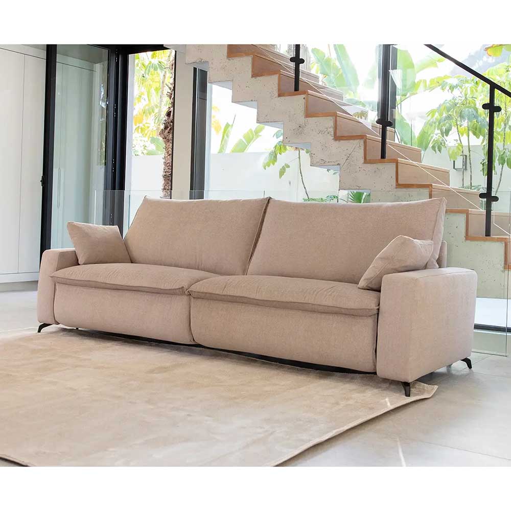 Beige sofa in a modern living room with a staircase in the background