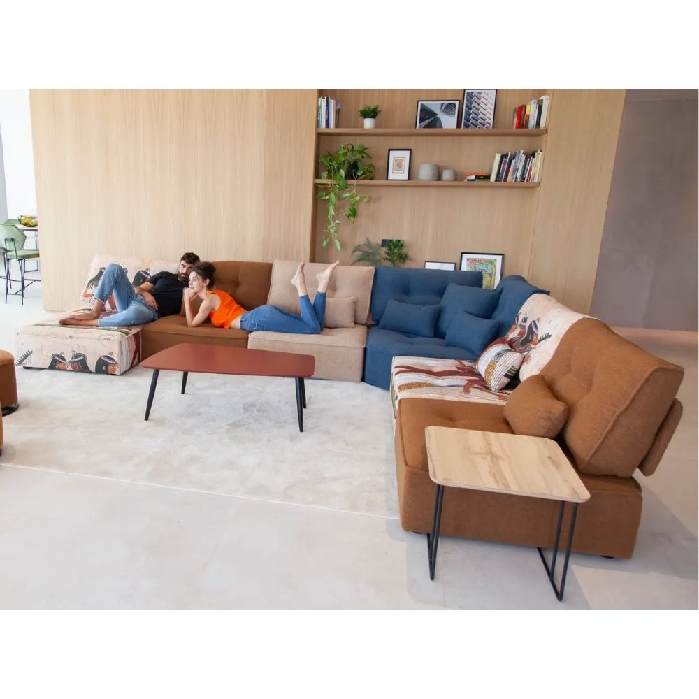 A modern sectional sofa set in a bright, contemporary living room. The set includes a U-shaped sofa in brown and beige, a separate brown armchair, a blue accent section, and matching coffee and side tables.