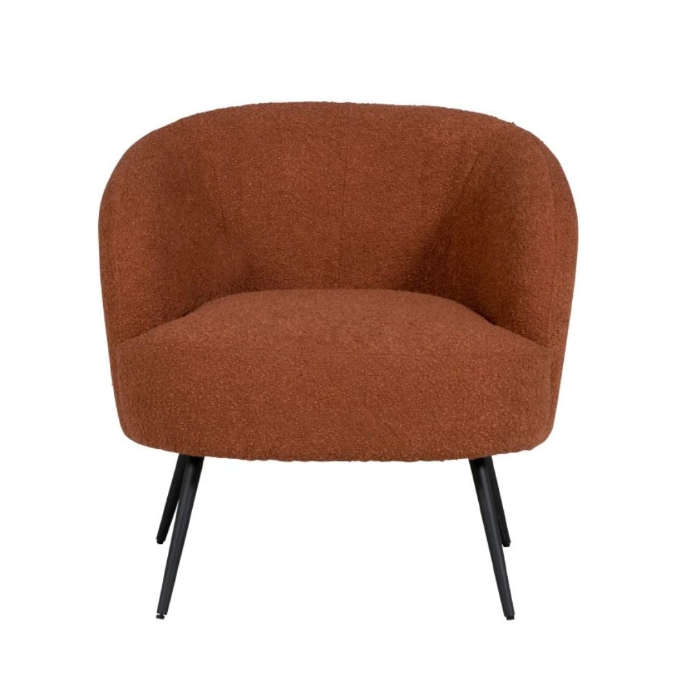 A modern barrel-style armchair upholstered in a textured terracotta-brown bouclé fabric, supported by four tapered black metal legs, shown against a plain white background.