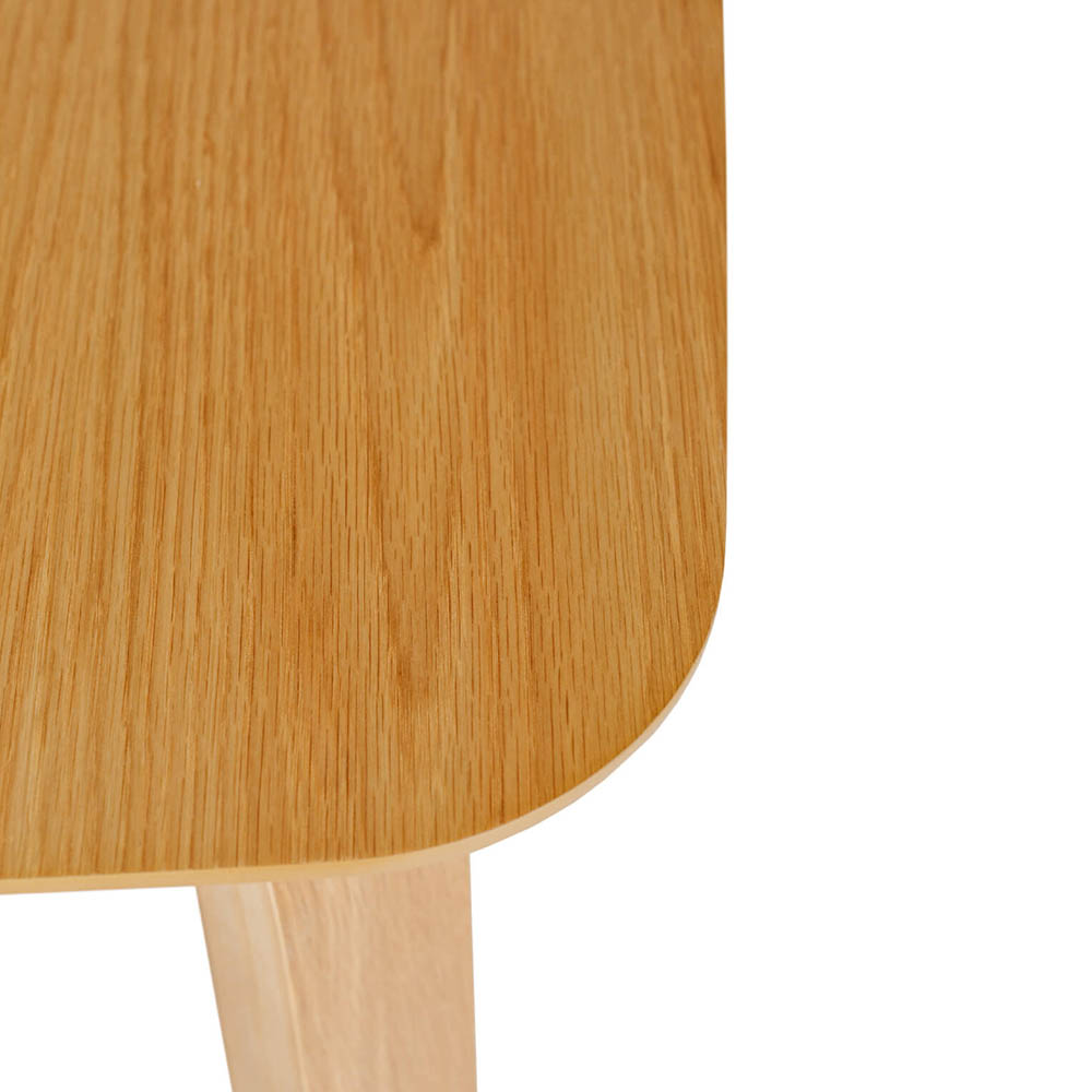 Close-up of a wooden table corner on a white background