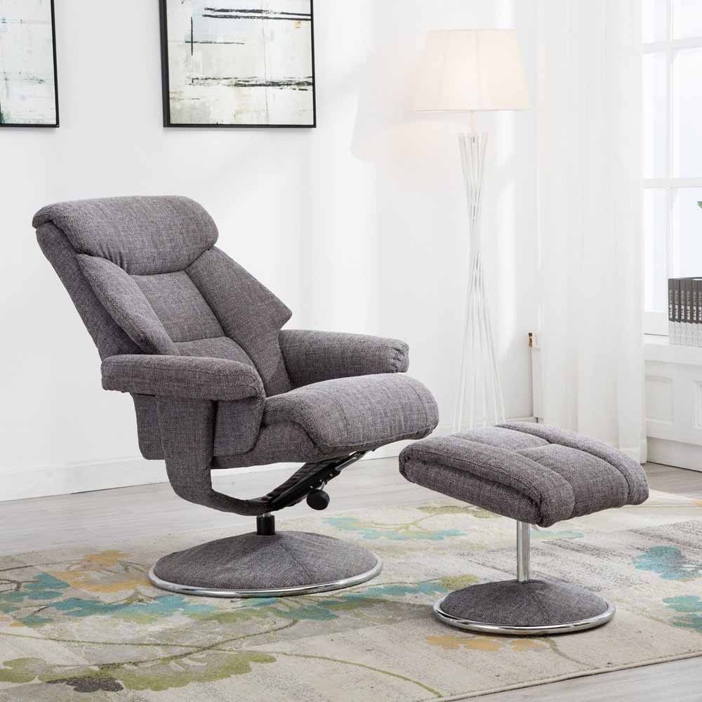 Gray recliner chair with footstool in a room with abstract art and lamp.