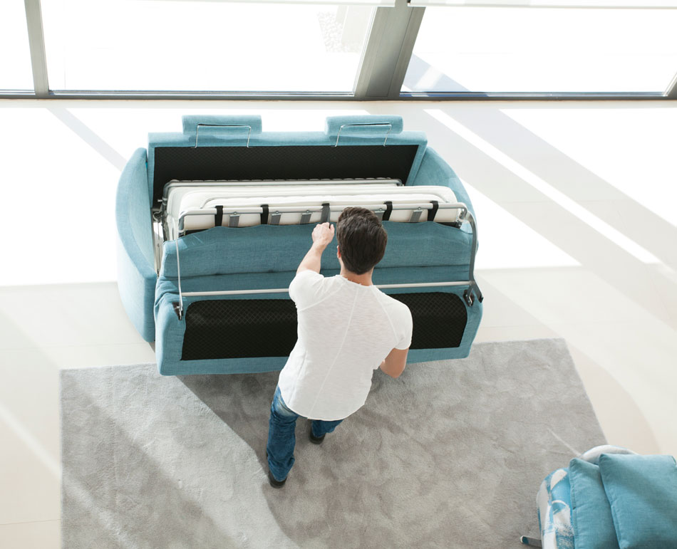 Overhead view of Sofa bed being easily reclined from sofa into bed by model