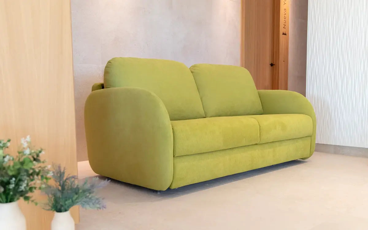 Green sofa in a room with light-colored walls and floor.