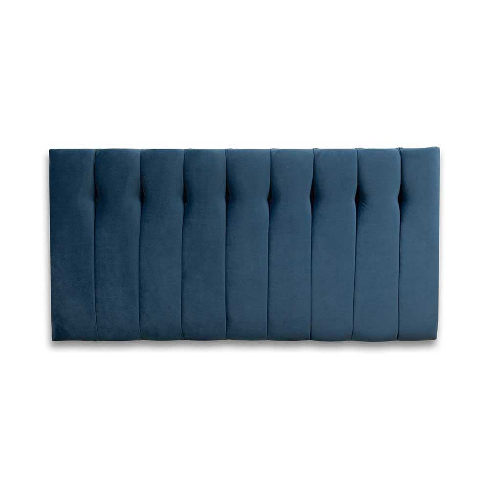 Blue tufted headboard on a white background
