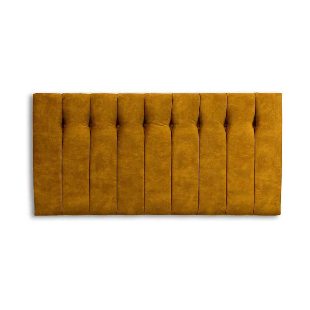 Mustard yellow tufted headboard on a white background
