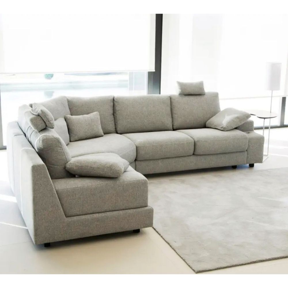 Gray modular sofa in a modern living room with large windows.