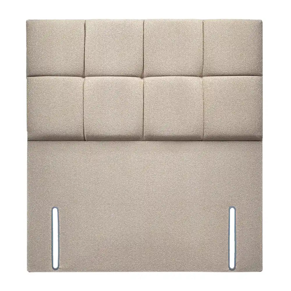 Beige upholstered headboard with square panels on a white background