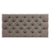 Brown tufted headboard on a white background