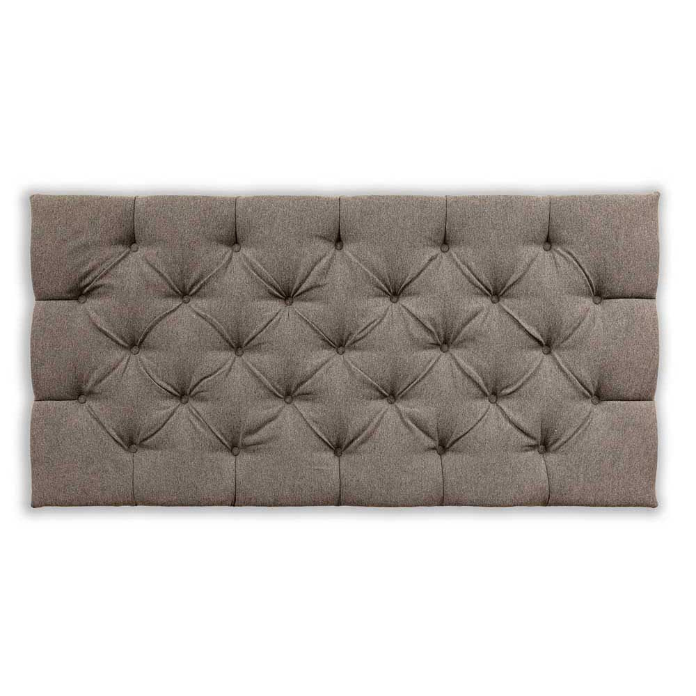 Brown tufted headboard on a white background