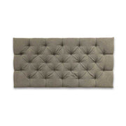 Gray tufted headboard on a white background
