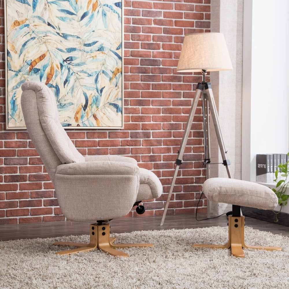 Modern living room with a 'wheat' coloured recliner chair, lamp, and abstract painting on a brick wall.