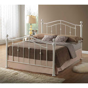 Ivory painted metal bedframe in a bedroom setting
