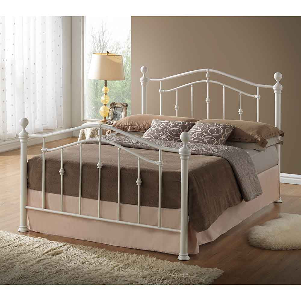 Ivory painted metal bedframe in a bedroom setting