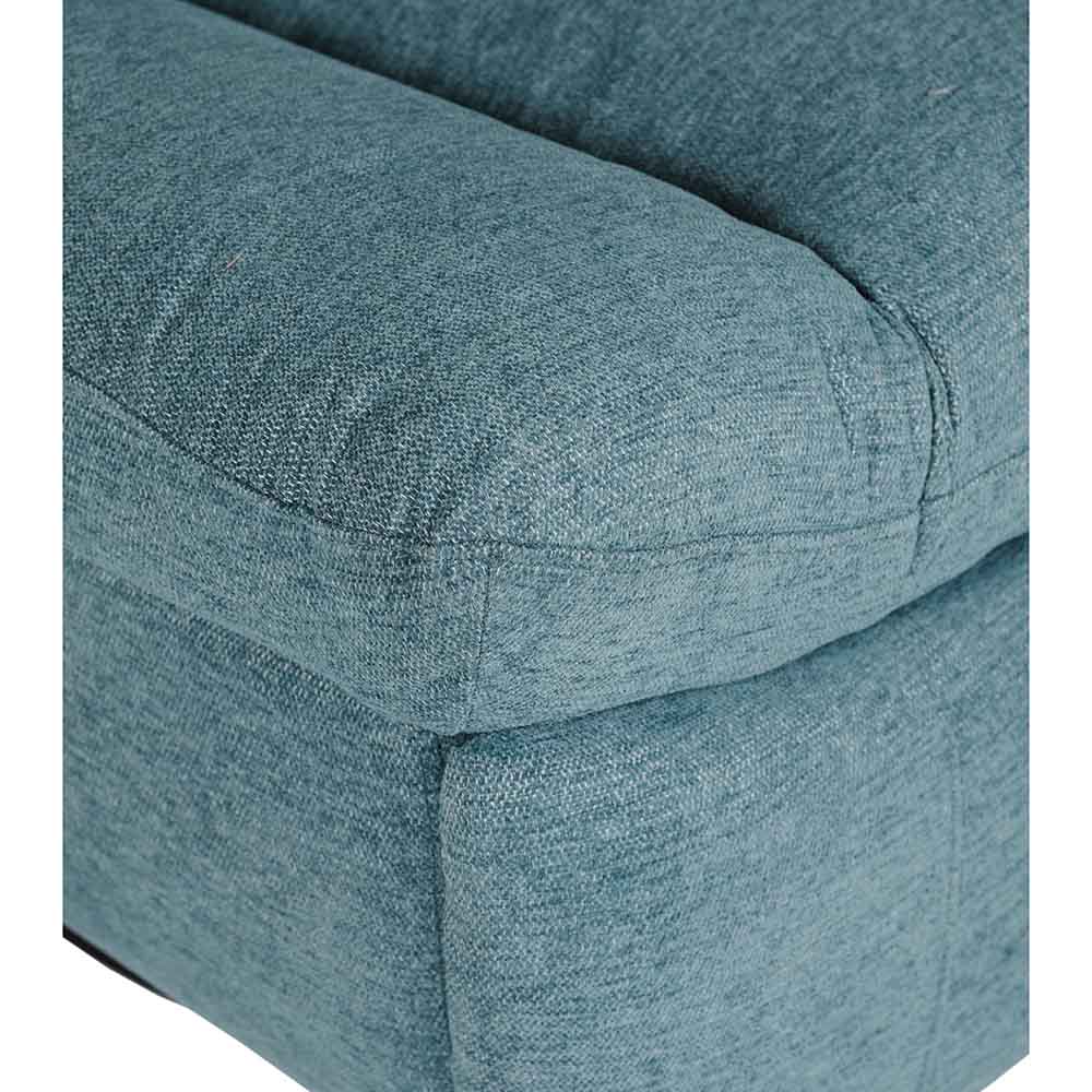Close-up of a blue upholstered chair with visible fabric texture.