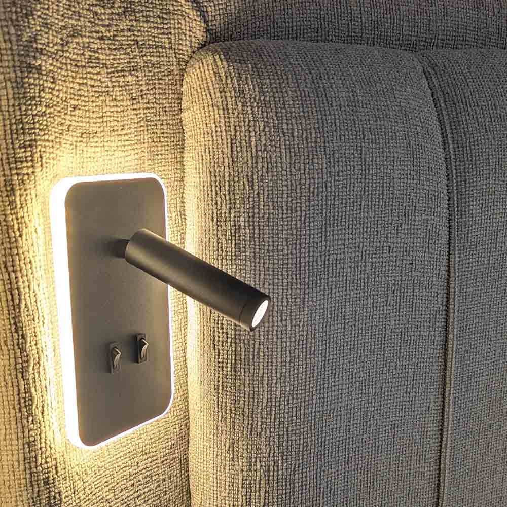 Modern wall light fixture on a fabric headboard