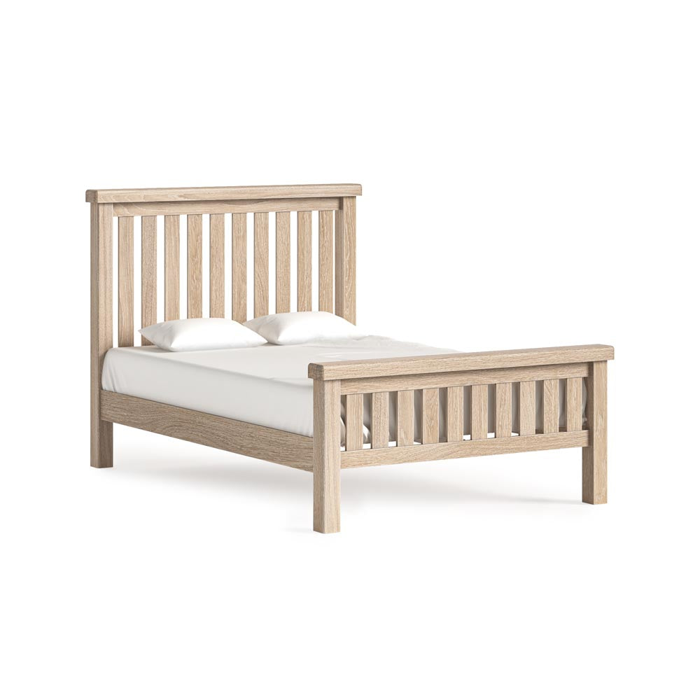 Wooden bed frame with white mattress on a white background