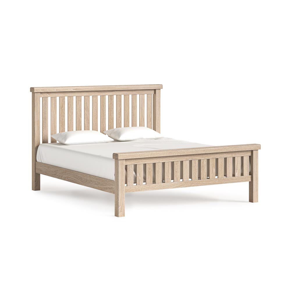 Wooden bed frame with white mattress on a white background