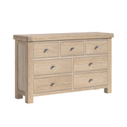 Wooden dresser with 7 drawers on a white background