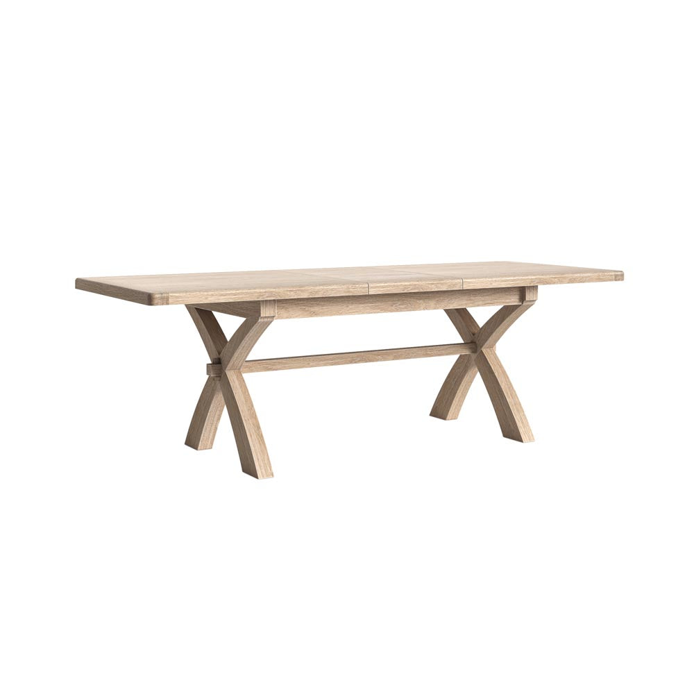 Wooden extended dining table with X-shaped legs on a white background