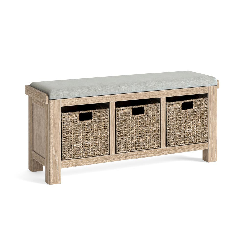 Wooden bench with beige cushion and wicker storage baskets on a white background