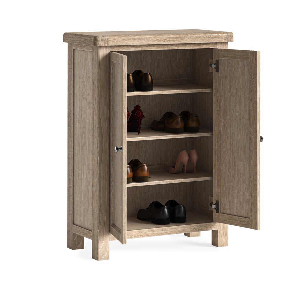 Wooden shoe cabinet with open doors displaying various shoes on a white background