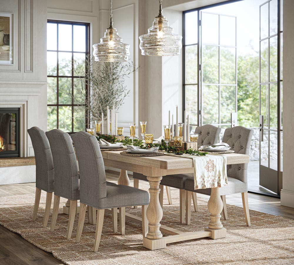 Dining room with a wooden table and gray chairs, decorated for a meal.