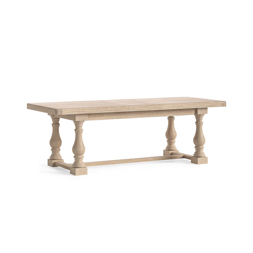 Wooden dining table with turned baluster legs on a white background