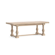 Wooden dining table with turned baluster legs on a white background