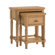 Set of two nesting wooden side tables, one with drawers on a white background