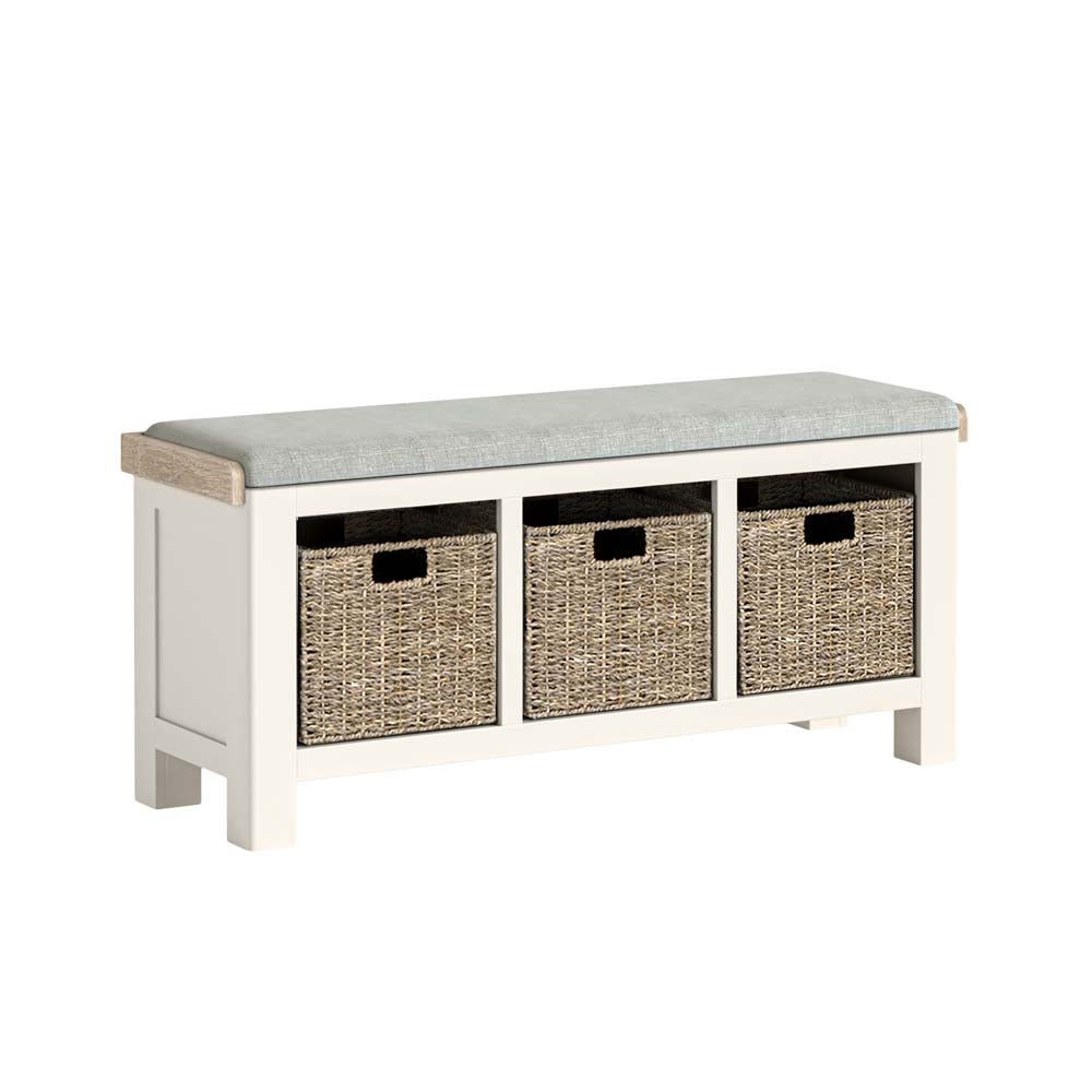 White bench with beige cushion and three woven basket storage compartments on a white background