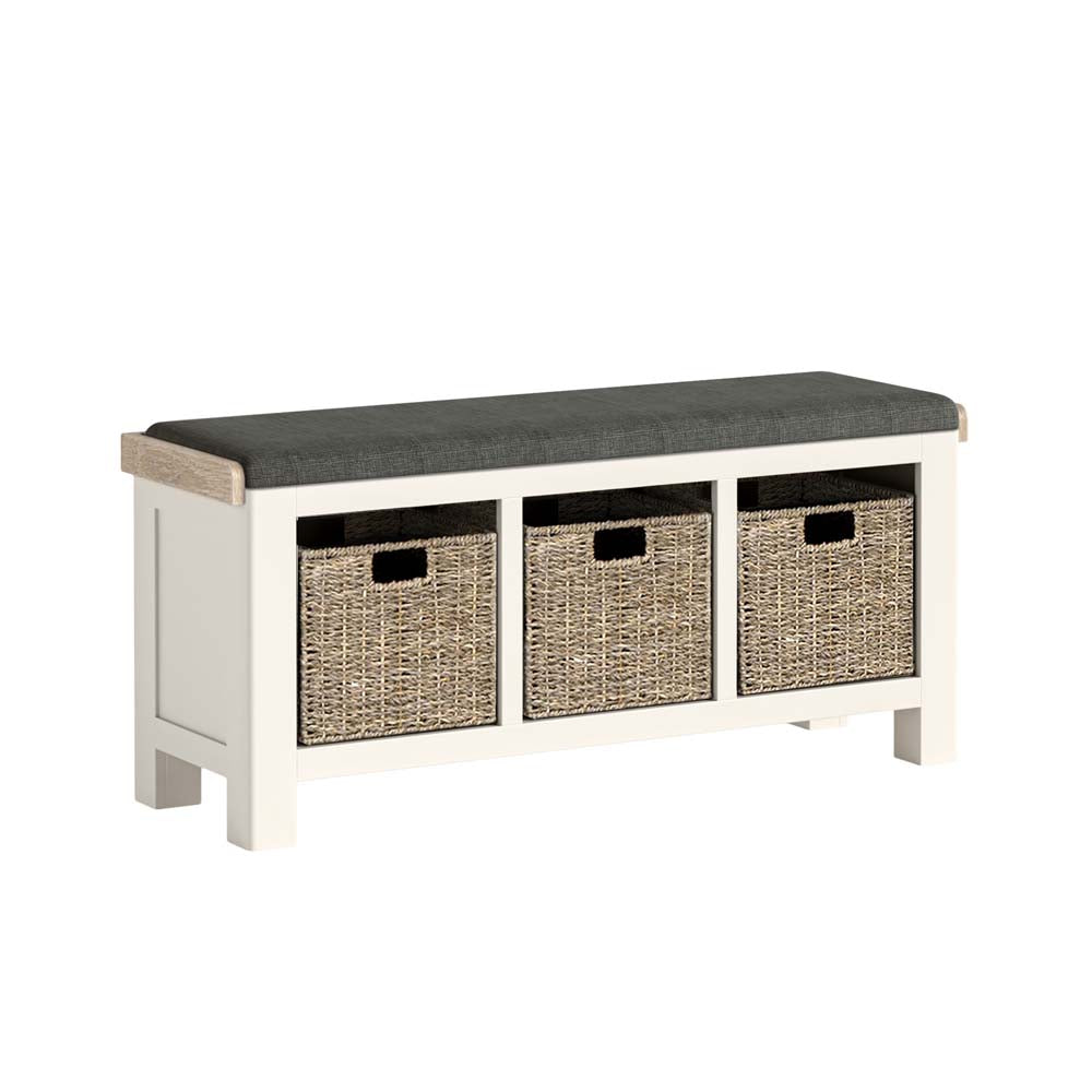 White bench with dark cushion and three wicker storage baskets on a white background