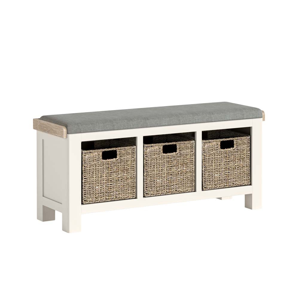 White bench with gray cushion and three wicker baskets on a white background
