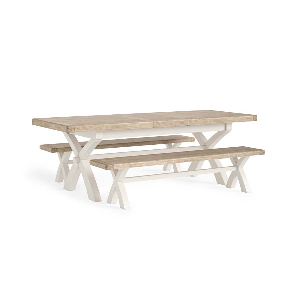 Wooden dining table with two matching dining benches on a white background