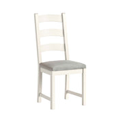 White chair with a beige cushion on a white background