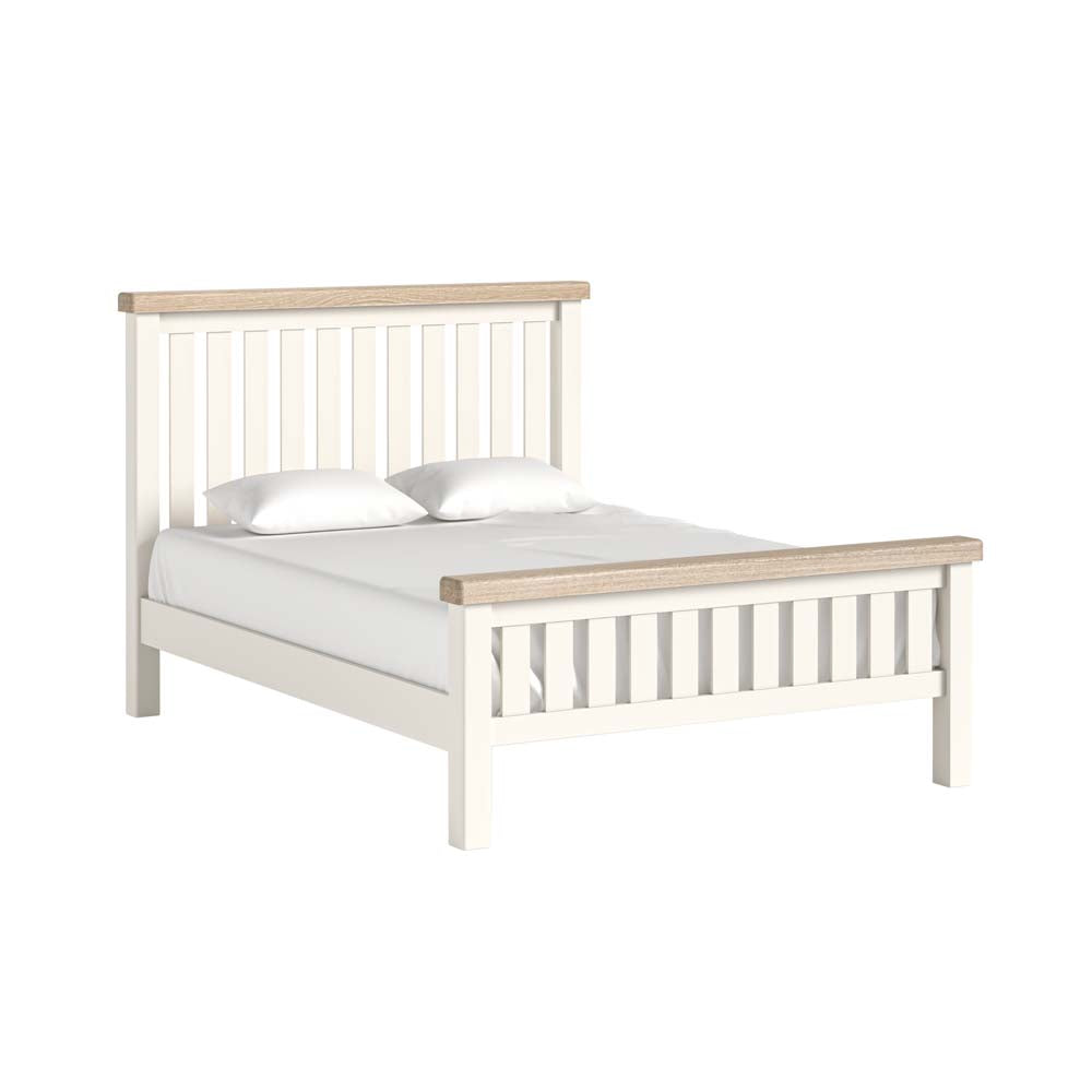 Wooden bed frame with white mattress and pillows on a white background